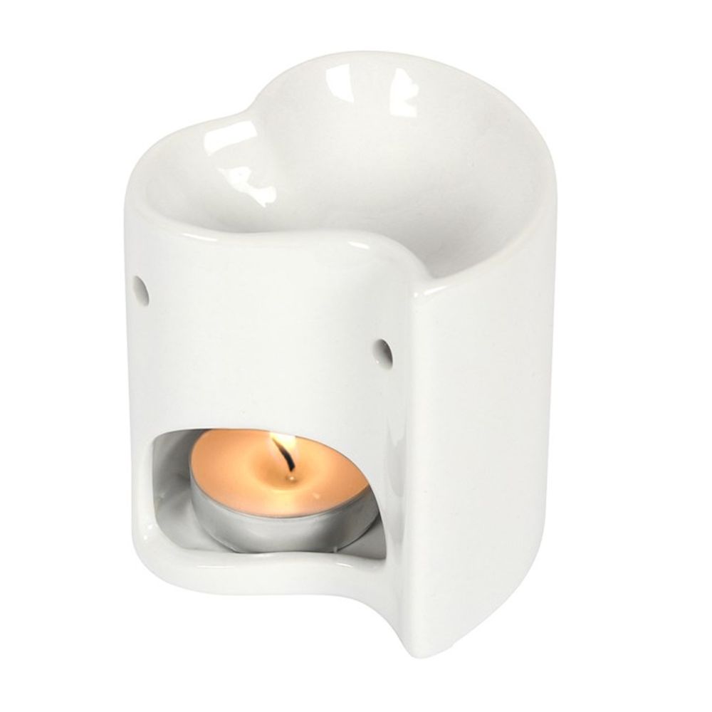A white ceramic oil burner with a charming heart design, featuring a hollow shape and an opening at the base for a tealight—perfect for heating essential oils or for use as a wax melt burner.