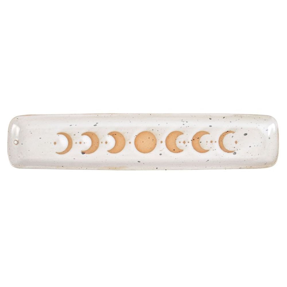 A long, rectangular stoneware incense holder boasts a speckled white surface. Its moon phase design, ranging from crescent to full in striking orange, stretches across the centre. Perfect for various home decor styles, a small hole at one end securely holds an incense stick.