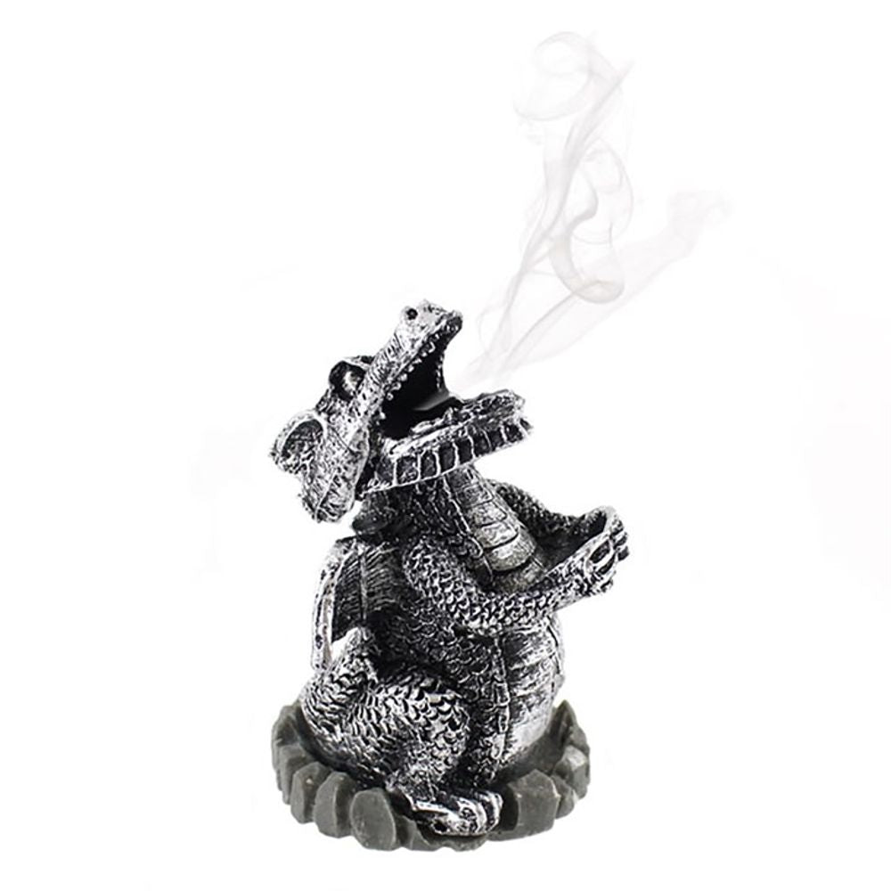 A silver resin dragon-shaped incense cone holder with intricate scales emits smoke billowing gracefully from its nostrils. The dragon perches on a circular base, sending tendrils of fragrant mist upwards.