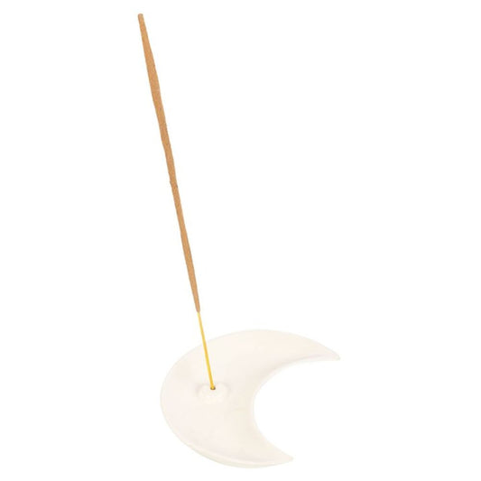 A crescent moon-shaped ceramic incense holder, featuring a modern design, cradles a single unlit incense stick. The stick stands upright in a small hole at one end of the crescent, set against a plain white background.