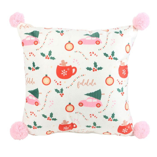 Square Christmas print cushion with pink pom-poms on each corner, featuring a festive holiday pattern of red mugs, pink cars with trees, holly, candy canes, baubles, and falalala on a white background.