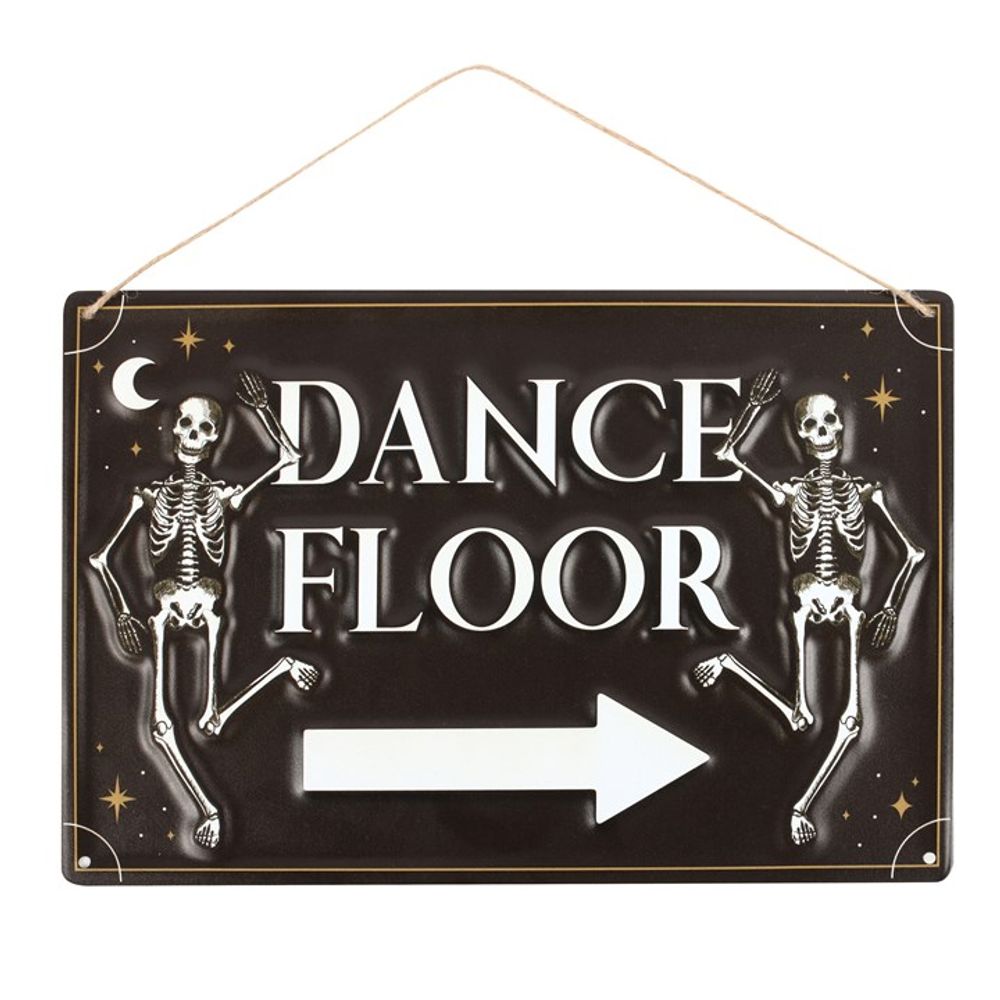 A black sign with white lettering reads DANCE FLOOR, flanked by dancing skeletons. A white arrow points to the right, while a crescent moon and stars decorate the corners—perfect party décor for your skeleton dance floor!.