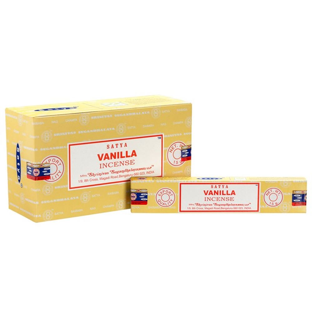 Two yellow boxes of Satya Vanilla Incense are displayed. The larger box is upright, while the smaller, crafted by skilled artisans, lies at the front. Both feature red and blue labels with text and a repeating pattern of the Satya brand logo, offering fragrant incense sticks inside.