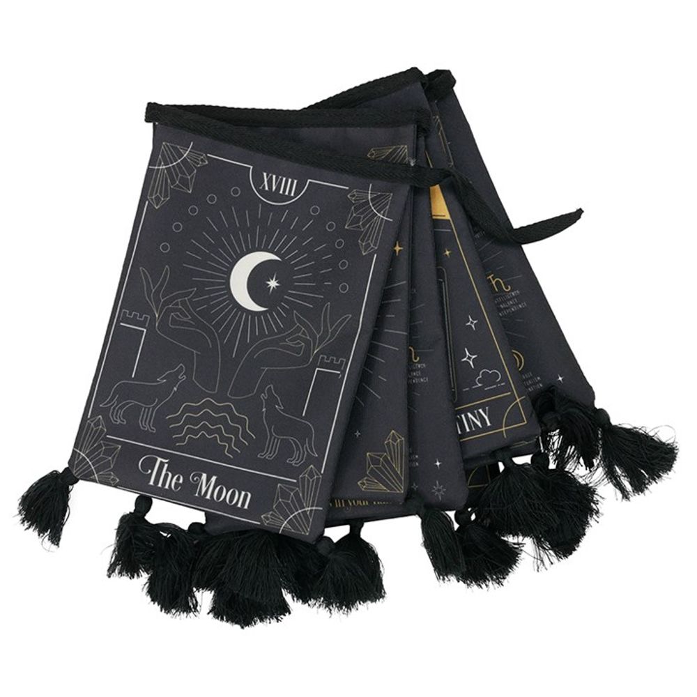 A black bunting garland features tarot card designs with gold line art, perfect for enthusiasts of divination tools. The visible card depicts “The Moon”, two wolves, celestial symbols, and tassels along the lower edge.