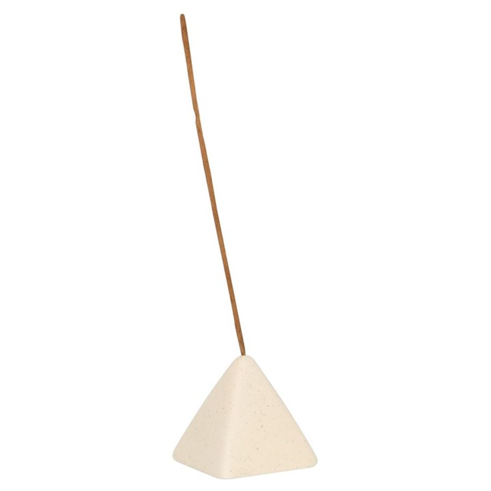A stylish, beige incense stick holder with a pyramid design features a single brown incense stick standing upright from a small hole near the top, set against a plain white background.