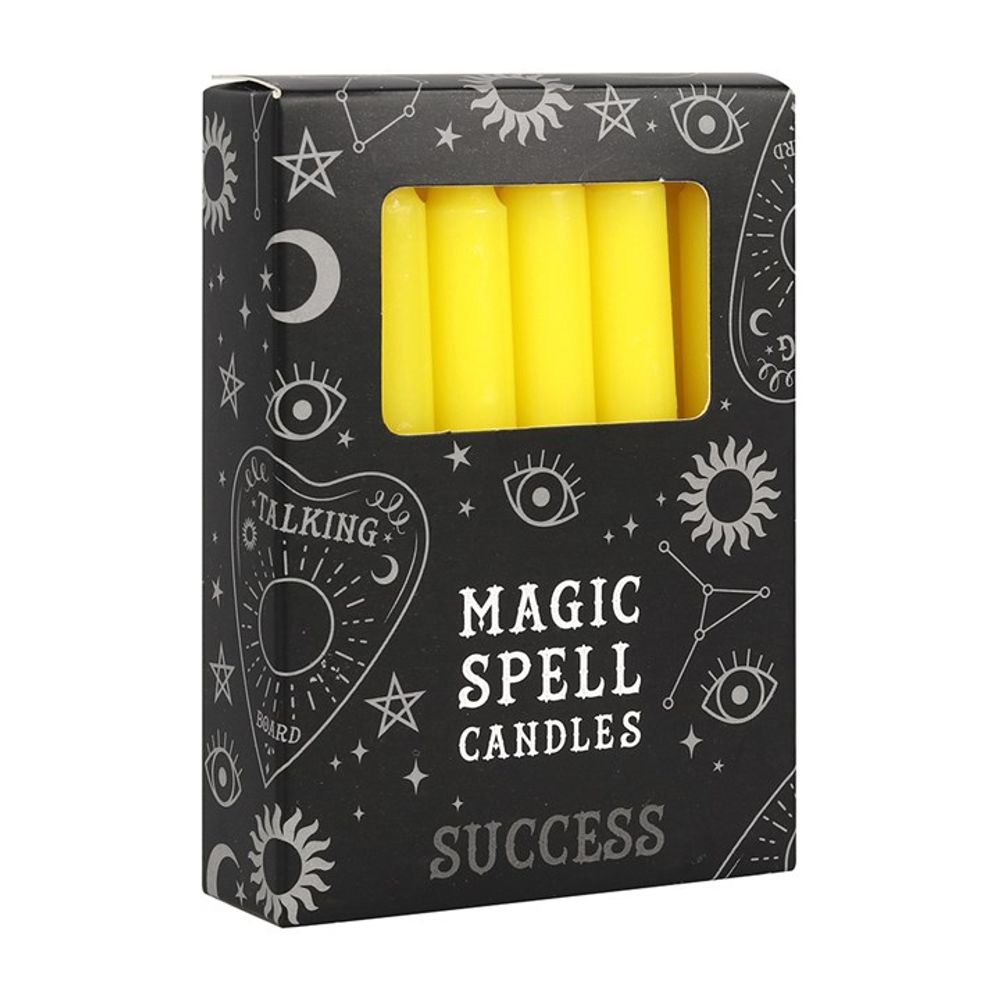 A black box of Magic Spell Candles, featuring yellow spell candles visible through a transparent window. Adorned with mystical symbols such as eyes, moons, and stars, the box is perfect for those who believe in candle magic and wish to attract success with the power of words like Success and Talking to the Bird.