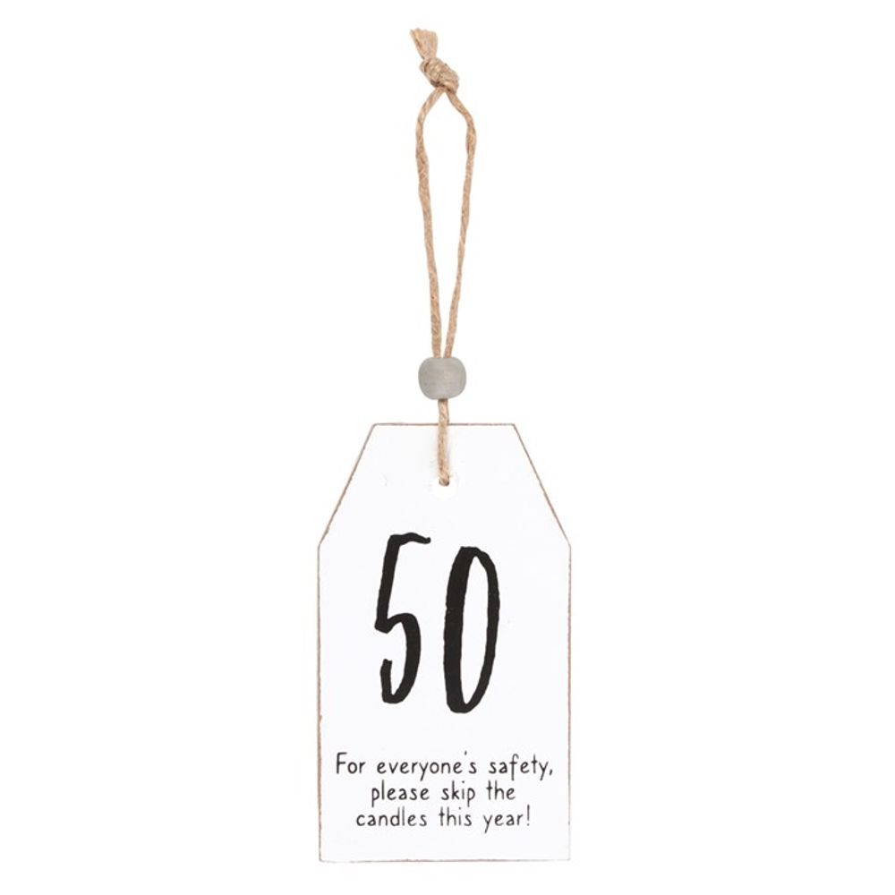 A white wooden tag with a string reads “50” in large black lettering. Beneath, smaller text states: “For everyone’s safety, please skip the candles this year!”—a perfect decorative sentiment.