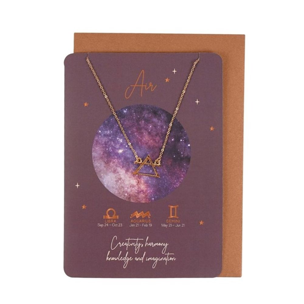 A gold Air signs necklace rests on a purple galaxy card featuring zodiac jewellery symbols (Libra, Aquarius, Gemini) and words such as Curiosity and Harmony. An envelope sits behind this stainless steel necklace display.