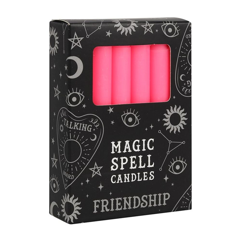 A black box labelled Magic Spell Candles with Friendship inscribed underneath. Adorned with mystical symbols such as stars, moons, and eyes, it offers a glimpse of three pink spell candles within—ideal for rituals or enhancing your candle magic experiences.