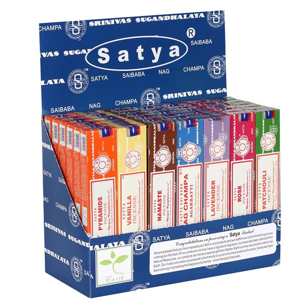 A blue display box labelled Satya showcases the finest Satya incense, including fragrances such as Nag Champa, Lavender, Rose, and Patchouli. Each incense box is vibrantly coloured and organised with the brandings circular logos, neatly stacked upright for an elegant presentation.