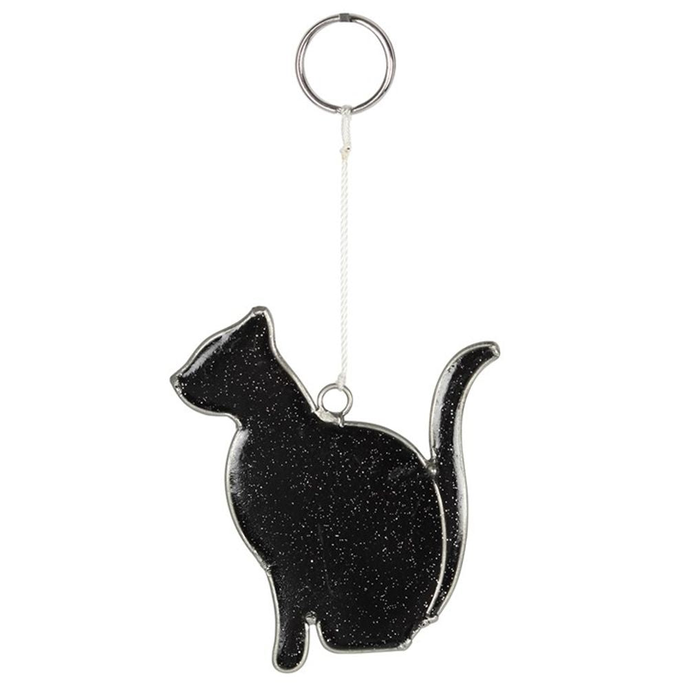 Silhouette of a sitting cat-shaped keyring, crafted from black glitter resin with white speckles resembling stars. Attached to a silver loop ring by a short white cord, this mystical cat sun catcher is designed as a reflective charm to sparkle in the sunlight and enhance visibility in low-light conditions.