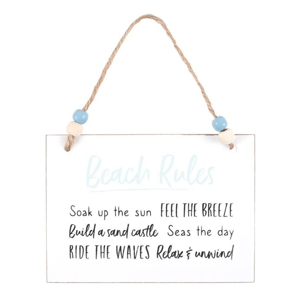 A wooden hanging sign, perfect as a gift for family and friends, features blue and white beads. It reads: Beach Rules - Soak up the sun, Feel the breeze, Build a sandcastle, Seas the day. The text combines light blue and black fonts.