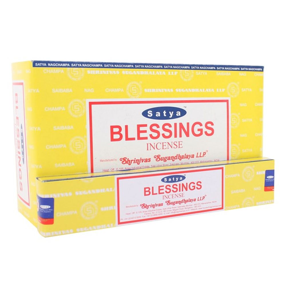 Yellow and white packaging for Satya Blessings incense. The larger, upright box features red text with branding such as Shrinivas Sugandhalaya LLP. A smaller box in front mirrors the design. Both feature a red and blue colour scheme and attest to being vegan-friendly, handmade creations.