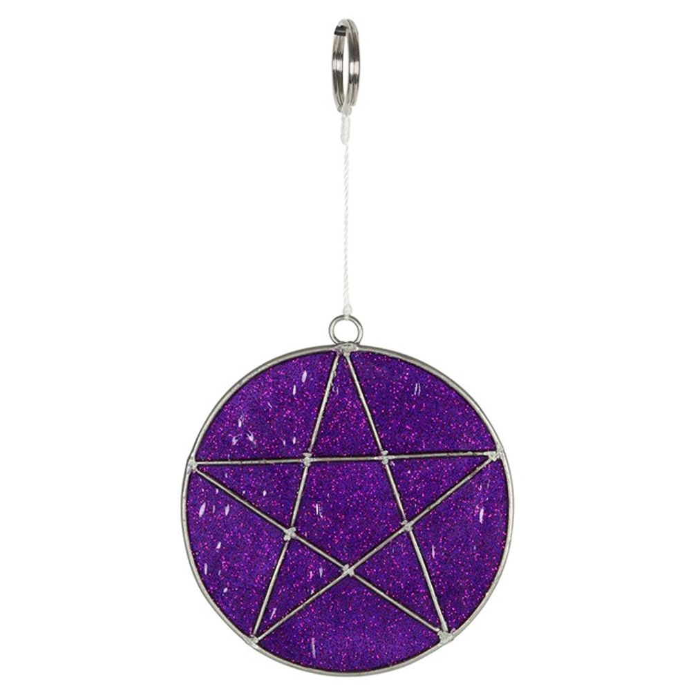 A mini suncatcher with a purple glittery background features a five-pointed star, outlined in metal and centred within the circle. This enchanting piece hangs elegantly from a metal ring and white cord, catching sunlight beautifully.