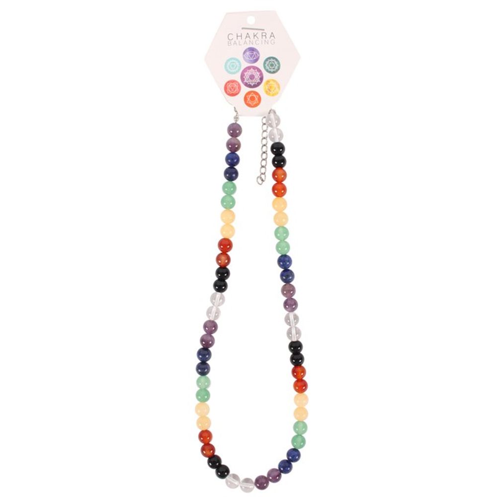 A colourful beaded necklace adorned with semi-precious stones in shades of purple, blue, green, yellow, orange, and red represents the Chakras. It is attached to a hexagonal card labelled Chakra Balancing with corresponding symbols.