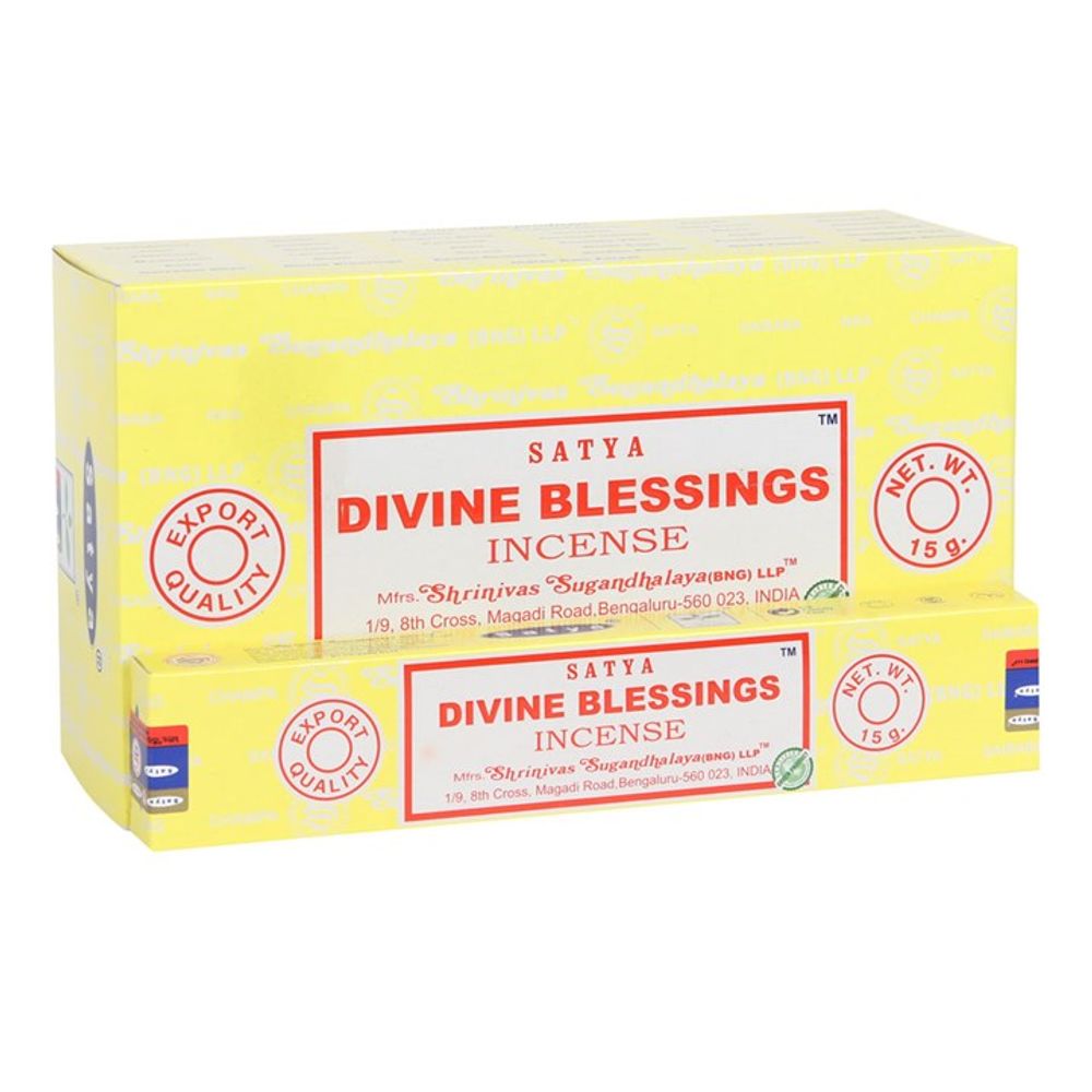 Yellow boxes of Satya Divine Blessings handmade incense. The larger box displays Export Quality and Net Wt. 15 g in red. Manufacturer details are in blue, with decorative elements and seals on the sides, offering a truly vegan-friendly experience.