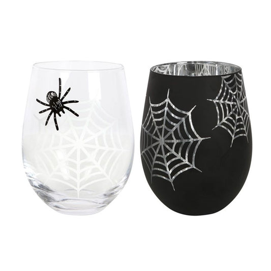 Two stemless wine glasses exude Halloween charm. One is clear with a white spider web design and black spider, while the other is black with silver webs. Both feature a smooth, curved shape, perfect for displaying their spooky elegance.