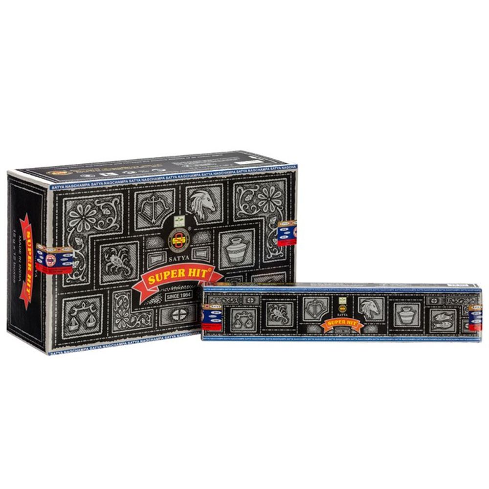 Two boxes of Satya Super Hit incense sticks are displayed. The larger box stands upright on the left, showcasing black and grey celestial and floral designs. The smaller box lies in front with similar patterns. Both feature a red banner with Super Hit in yellow text, highlighting their vegan-friendly attributes.