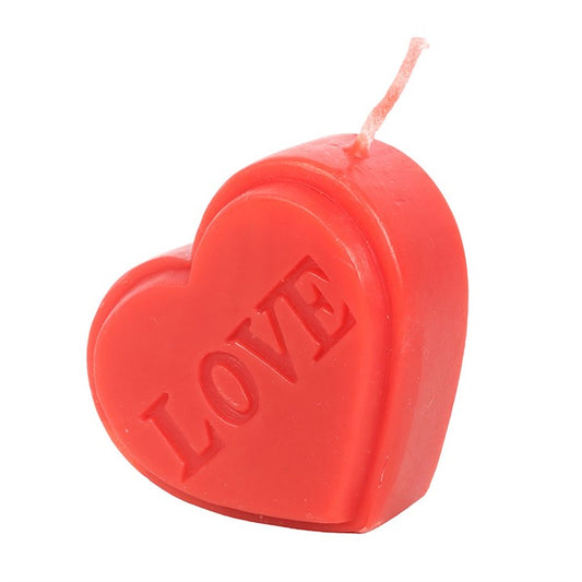 A red, heart-shaped candle with LOVE engraved on the front. This Valentine’s Day candle features a single wick at the top, making it a delightful gift set against a plain white background.