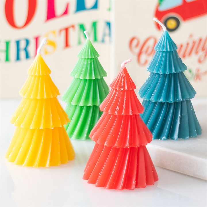 Four Christmas tree candles—yellow, green, red, and blue—feature ridged branches and sit in a row on a white surface, making them a charming festive decoration or stocking filler gift for the holiday season.