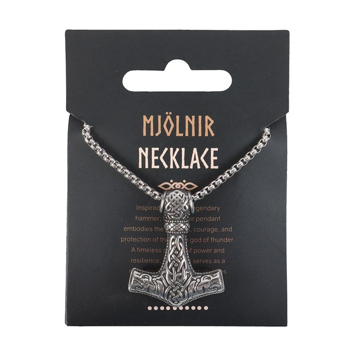 A silver metal Mjölnir necklace with a finely detailed Thors hammer pendant featuring intricate engravings, presented on a black card marked MJÖLNIR NECKLACE, honouring the might of the Norse gods.