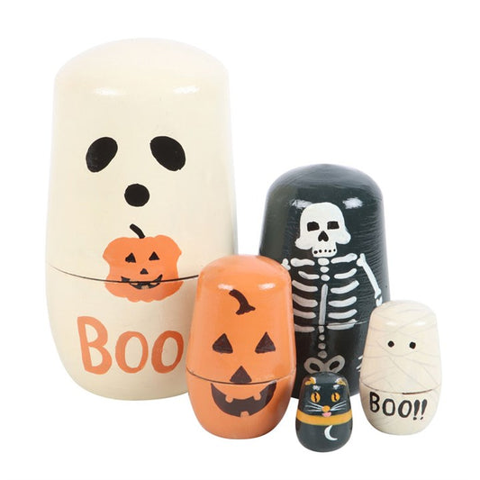 Five hand-painted Halloween wooden Russian nesting dolls—a ghost with BOO and pumpkin, a skeleton, a pumpkin face, a black cat with yellow eyes, and a mummy—make a charming Halloween decoration in festive colours.