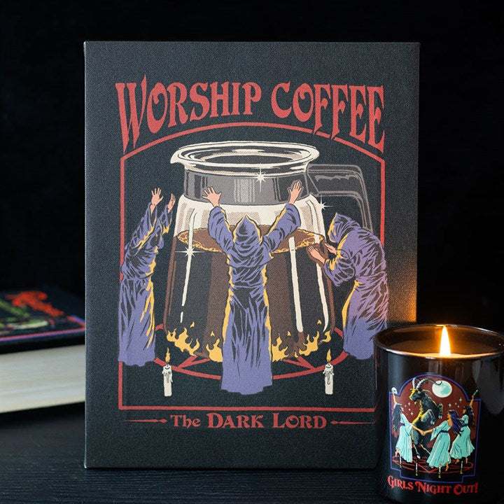 A Steven Rhodes-inspired canvas print depicts three robed figures with raised arms worshipping a giant coffee pot set atop flames. Perfect for fans of quirky, retro gifts, it features “WORSHIP COFFEE” above and “The DARK LORD” below.
