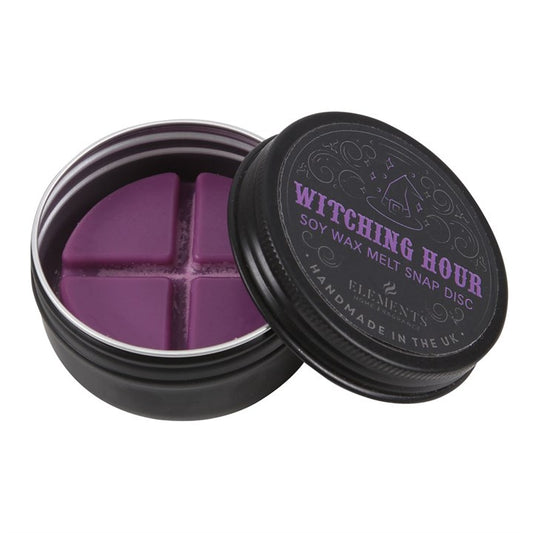 A round black tin contains a purple vegan wax melt, split into four segments. The lid reads “Witching Hour Soy Wax Melt Snap Disc,” ideal for bringing a hint of Gothic home fragrance to your space.