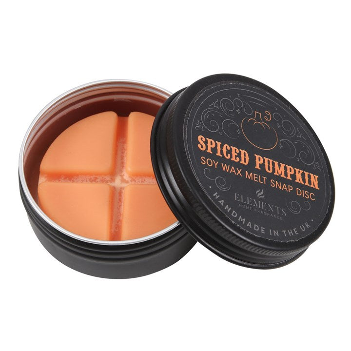 A round black tin labelled Spiced Pumpkin Soy Wax Melt Snap Disc with the lid partially off, revealing an orange wax disc inside divided into four sections—a gothic home fragrance, handmade in the UK.