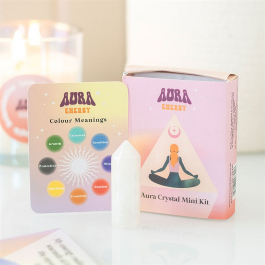 A pastel-coloured Aura Crystal Mini Kit displays an illustration of a meditating woman, a white pointed crystal for crystal energy, and a card describing colour meanings: Growth, Calmness, Intuition, Protection, Optimism, and Creativity.