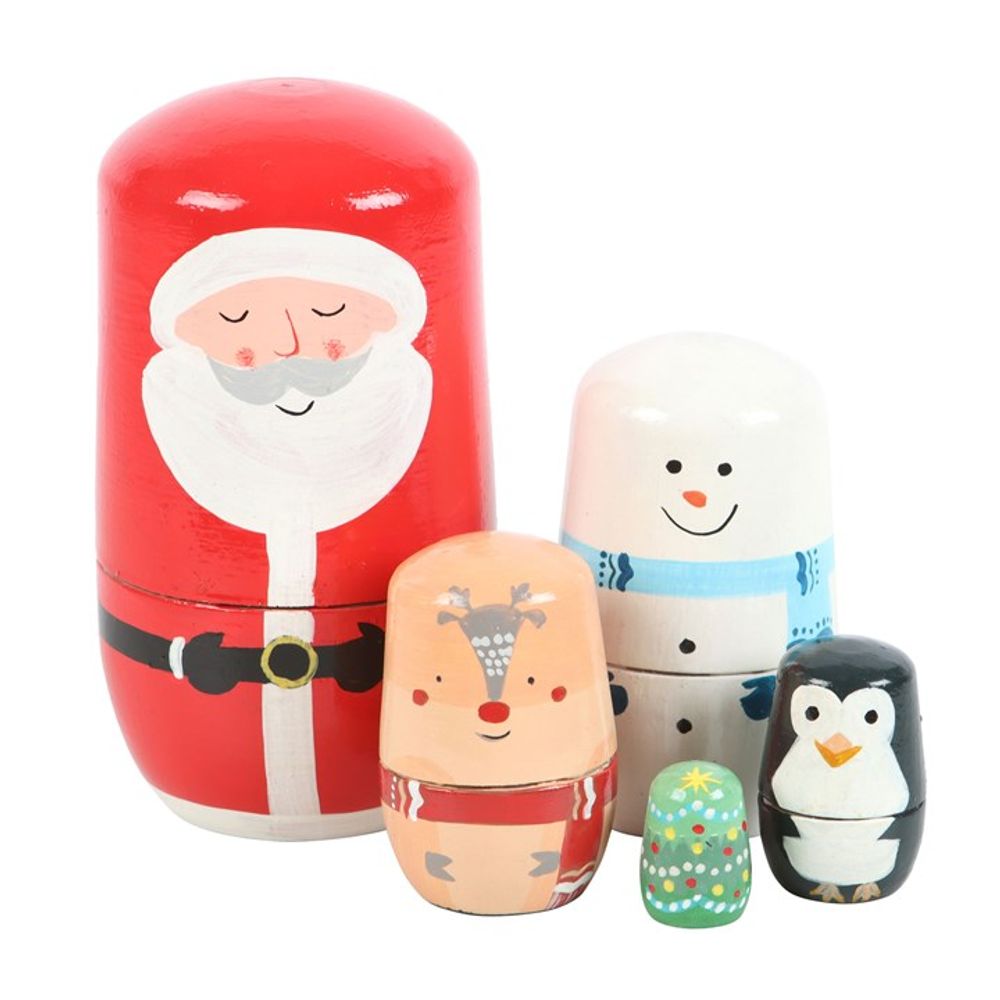 This classic set of five Christmas nesting dolls features hand-painted designs: a red Father Christmas, a white snowman with a blue scarf, a tan reindeer with a red nose, a black penguin, and the smallest—a green Christmas tree adorned with baubles—all diminishing in size.