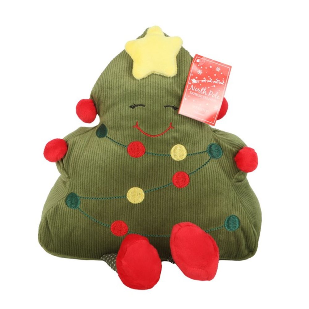 A plush cushion shaped like a smiling Christmas tree serves as a charming Christmas doorstop. It features a yellow star on top, red pom-poms as baubles, and embroidered garlands with red and green circles. The tree has a cheerful face, wears red shoes, and sports a festive tag on the upper right.